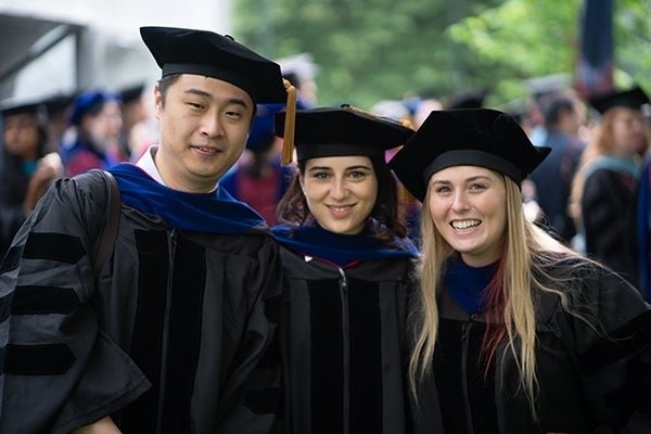 Three students posing in their graduation gowns