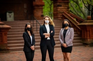 Carson Eckhard (left), Sarah Simon (center) and Natalia Rommen (right) pose in front of a building on Penn's campus; Photo Credit: Eric Sucar / University of Pennsylvania